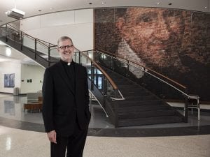 The Rev. Dennis H. Holtschneider, C.M., president of DePaul University, is seen in a portrait in the McGowan South science building on DePaul's Lincoln Park campus quad Monday June 29, 2015. (DePaul University/Jeff Carrion)